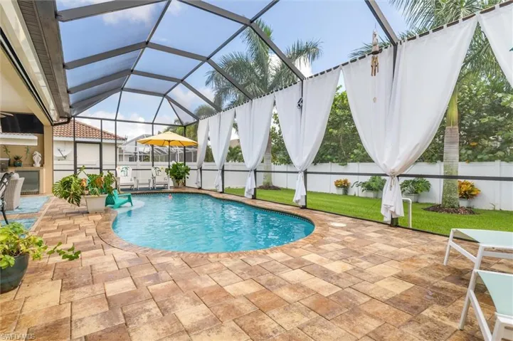 View of swimming pool featuring a lanai and a patio area