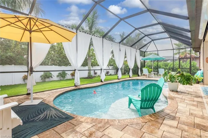 View of pool with a lawn, a lanai, and a patio area