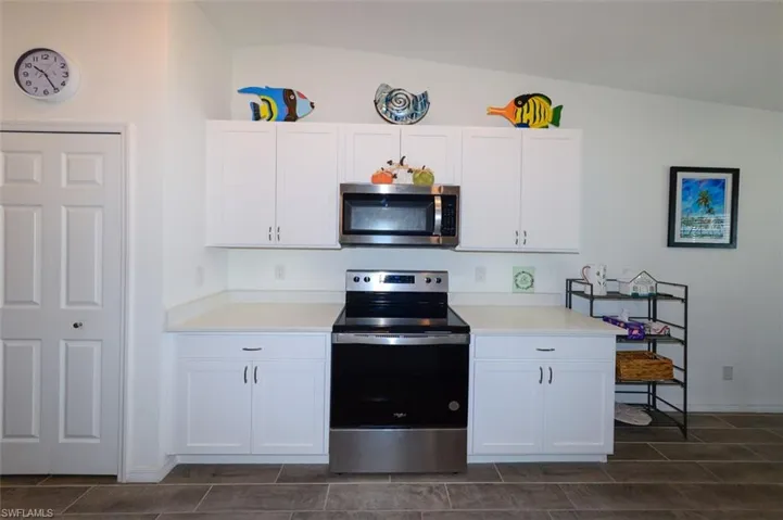Kitchen with stainless steel appliances and white cabinetry