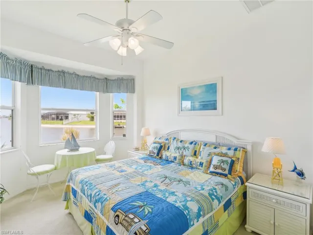 Carpeted bedroom with ceiling fan