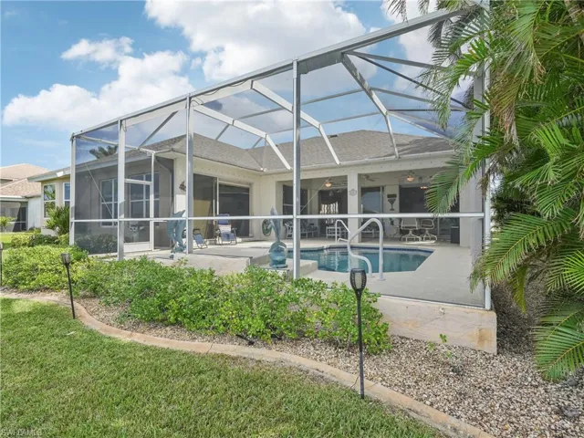 Rear view of house with a lanai, ceiling fan, and a patio