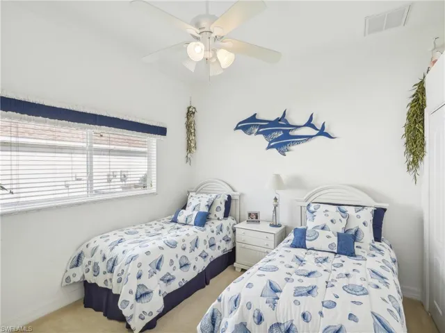 Bedroom featuring ceiling fan and light carpet