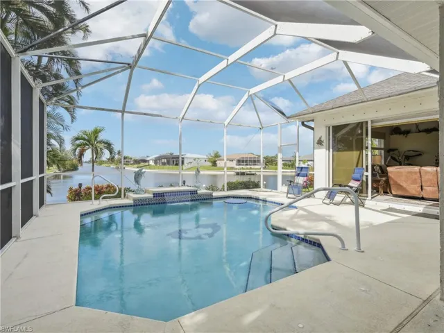 View of swimming pool featuring a patio, a water view, and a lanai