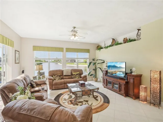 Living room featuring ceiling fan and light tile patterned flooring