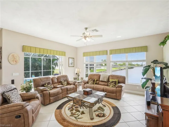 Living room featuring ceiling fan and light tile patterned flooring