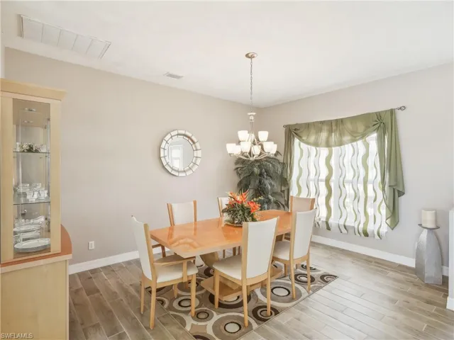 Dining room with wood-type flooring and a chandelier