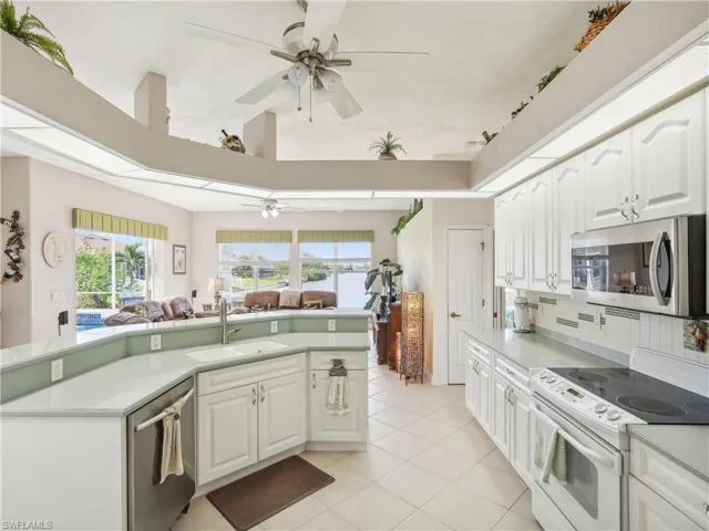 Kitchen featuring white cabinets, a healthy amount of sunlight, sink, and appliances with stainless steel finishes