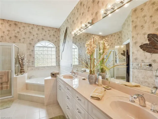 Bathroom with tile patterned floors, vanity, and independent shower and bath