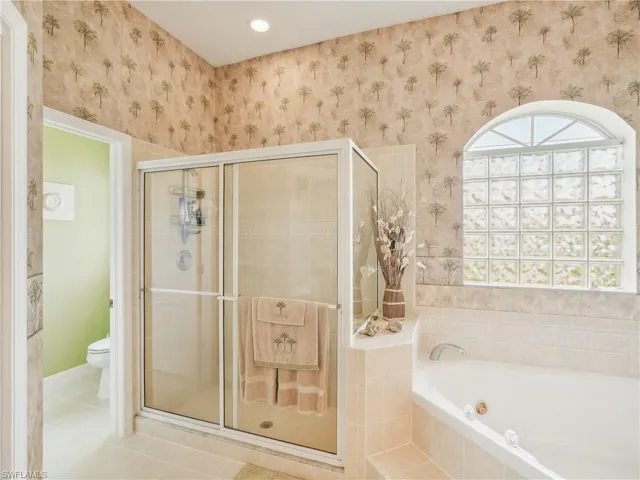 Bathroom with separate shower and tub, tile patterned flooring, and toilet