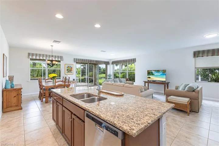Kitchen featuring light Granite counters,dishwasher, Wood cabinets, recessed lighting, and open floor plan