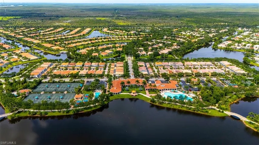 Aerial view of property's location with a large body of water and nearby suburban area