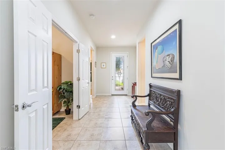 Hall featuring light tile patterned flooring and recessed lighting