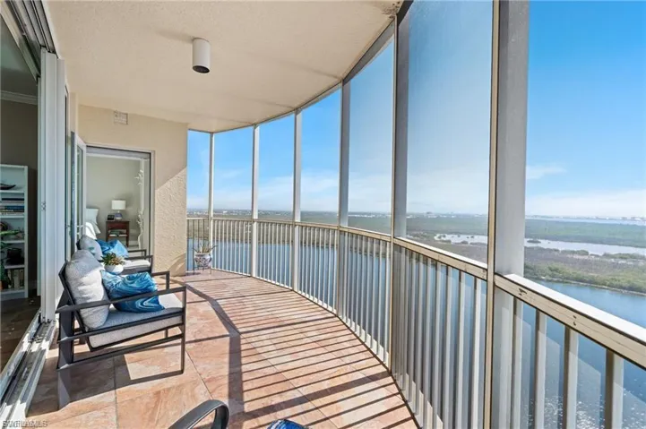 Sunroom with floor to ceiling windows and a water view