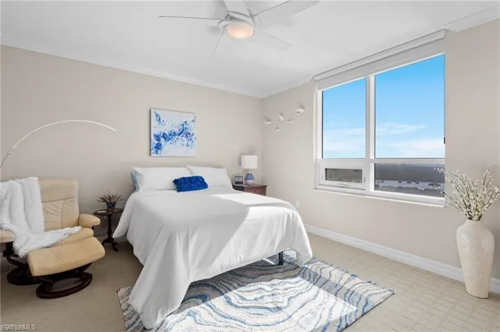 Bedroom with crown molding, a ceiling fan, and light flooring