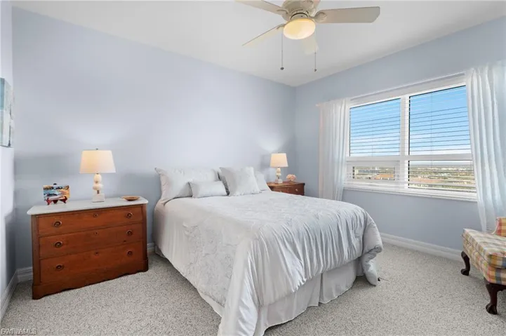 Bedroom featuring light colored carpet and ceiling fan