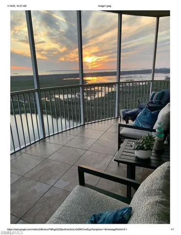 Balcony with a sunroom and a water view