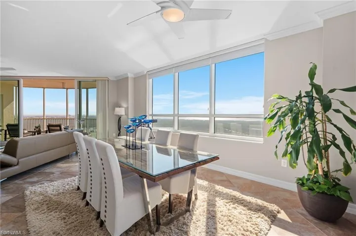 Dining area featuring ornamental molding, healthy amount of natural light, and ceiling fan