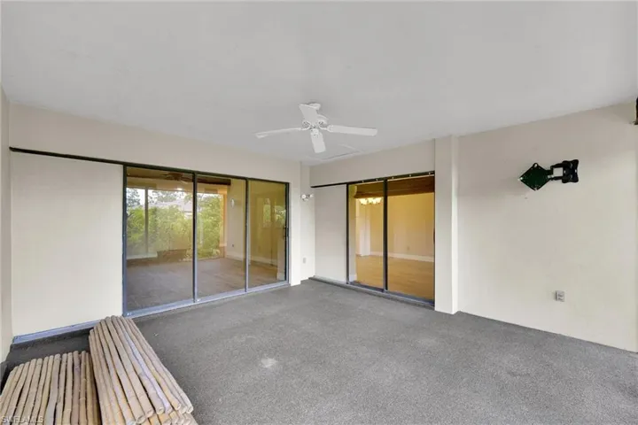 View of patio / terrace with ceiling fan and a sunroom
