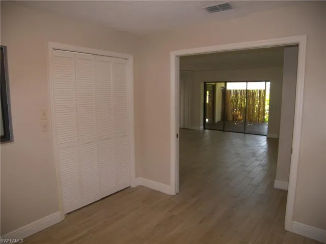 Unfurnished bedroom with light wood-style floors and a closet