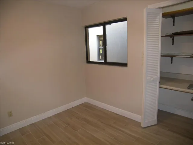 Unfurnished bedroom with light hardwood / wood-style flooring and a closet