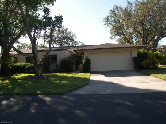 Single story home with a front yard and a garage