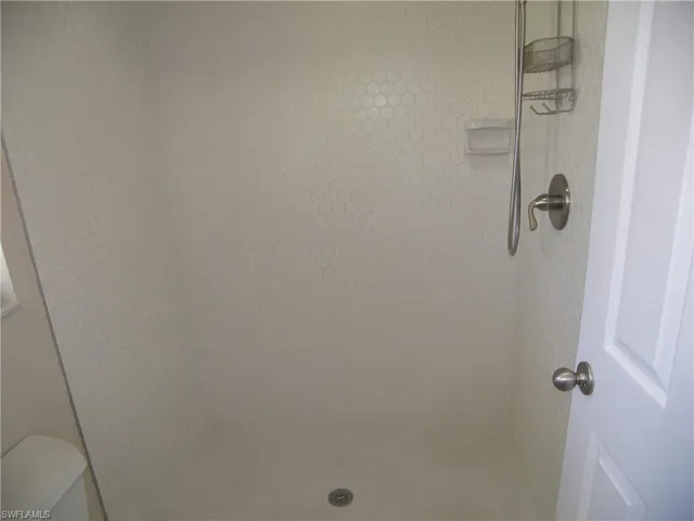 Bathroom with a tile shower and toilet