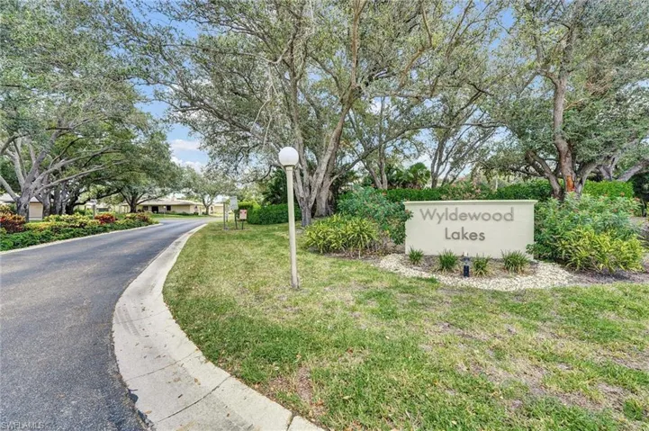Community / neighborhood sign with a yard