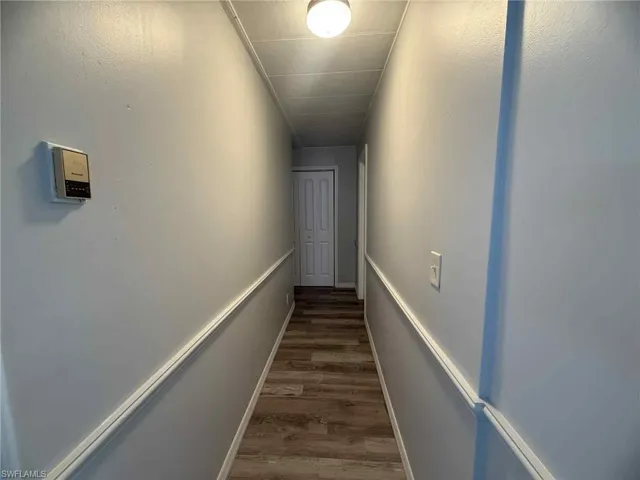 Corridor featuring wood finished floors