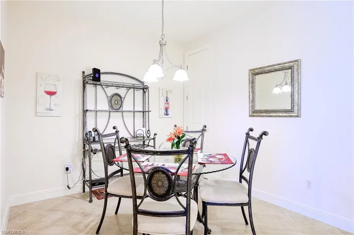 Dining room with baseboards and light tile patterned floors
