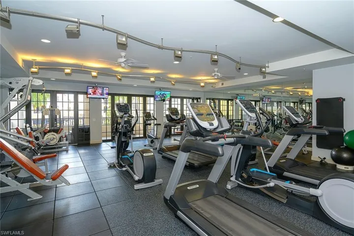 Exercise room with french doors and a ceiling fan