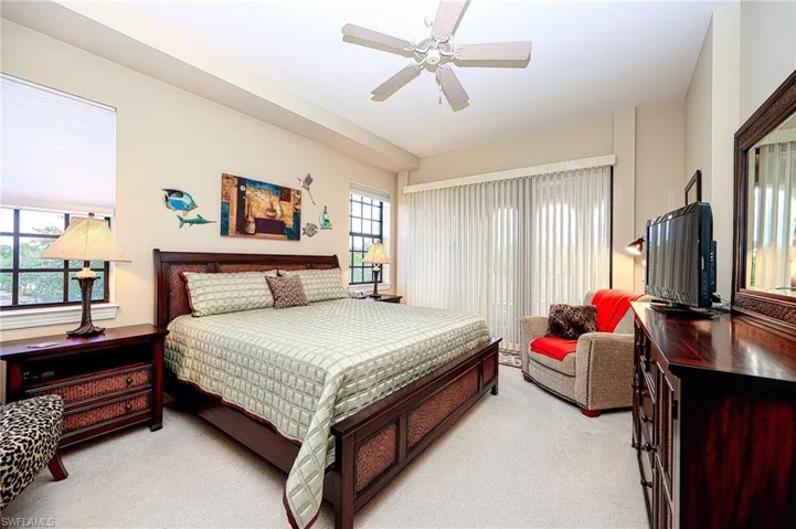 Bedroom featuring ceiling fan and light colored carpet