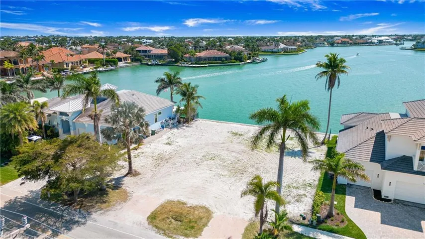 Aerial perspective of suburban area featuring a large body of water