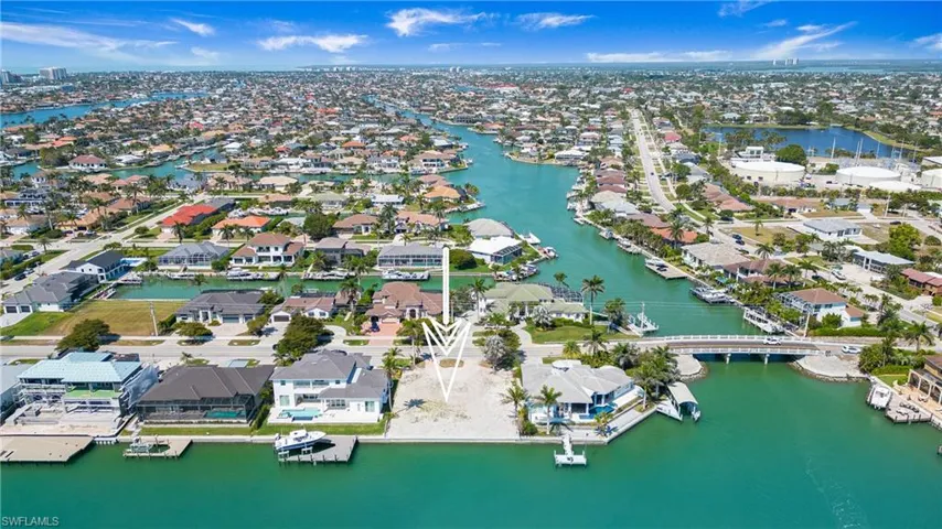 Aerial perspective of suburban area featuring a large body of water