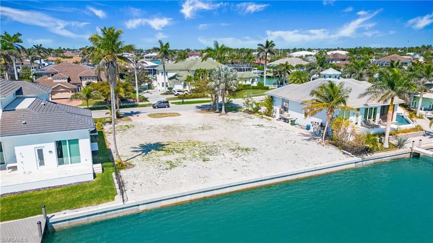 Aerial perspective of suburban area with a nearby body of water
