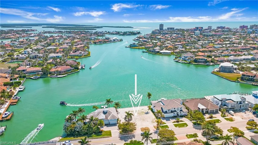 Aerial perspective of suburban area featuring a nearby body of water