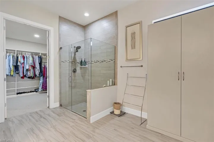 Bathroom featuring a shower with door