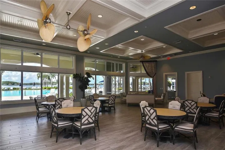 Dining area with ceiling fan, a healthy amount of sunlight, ornamental molding, and coffered ceiling