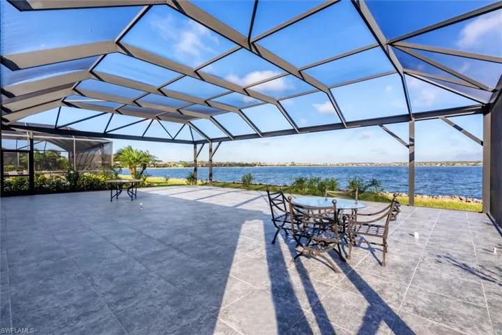 View of patio / terrace featuring a lanai and a water view