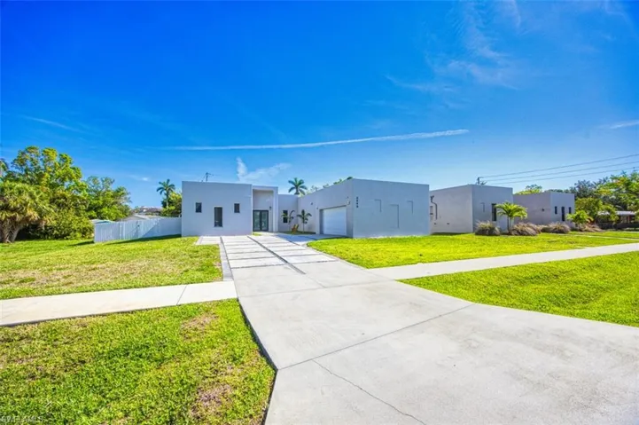 Contemporary home with stucco siding and concrete driveway