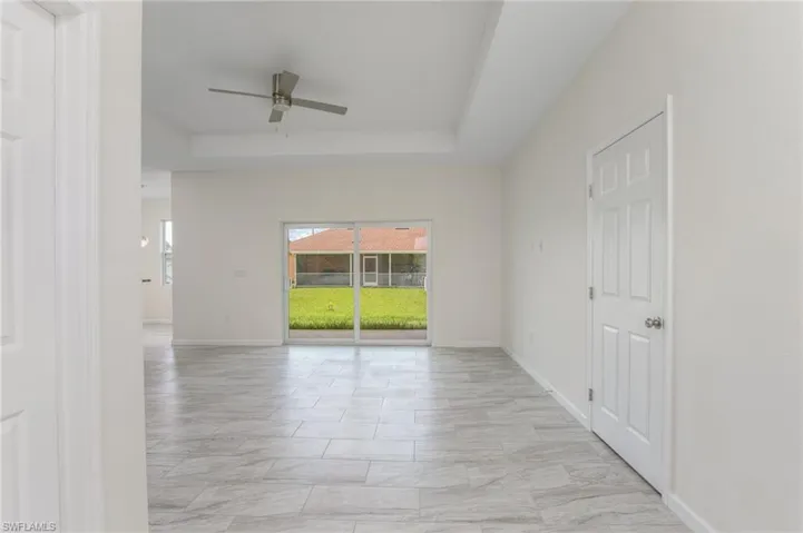As you enter the home, on the left is the first guest bedroom, on the right the door that leads to guest bathroom and two additional rooms, tray ceiling and ceiling fan