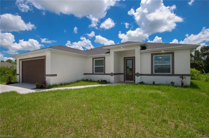 View of front facade featuring stucco siding, an attached 2 car garage, concrete driveway, and recess lighting