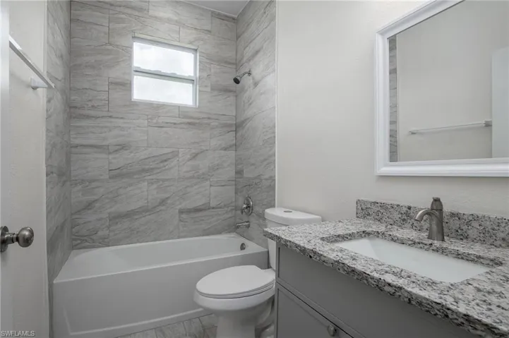 Guest bathroom featuring vanity and shower / tub combination