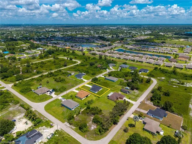 Aerial view of residential area with outlined property line
