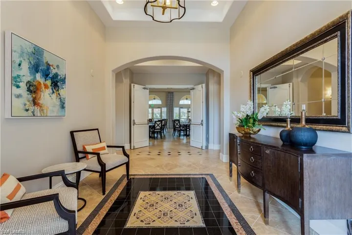 Entrance foyer with a notable chandelier and a raised ceiling