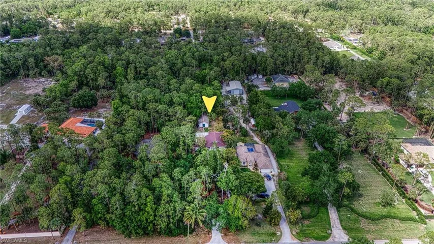 Birds eye view of property with a forest view