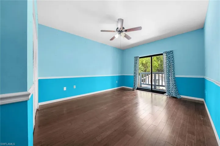 Spare room featuring ceiling fan, wood finished floors, and baseboards