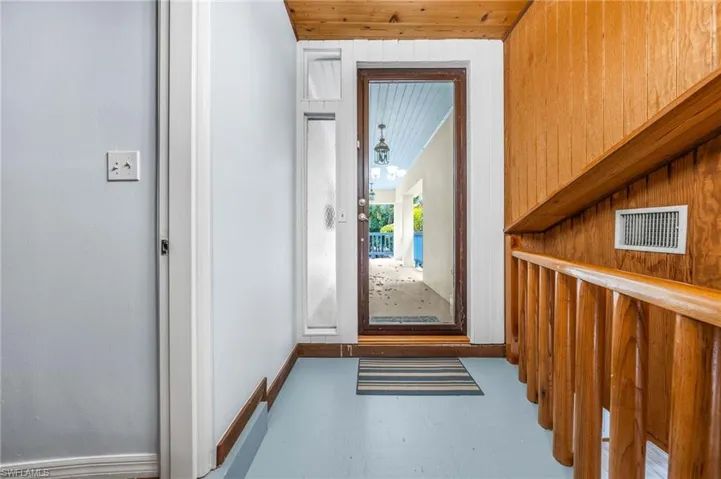 Doorway to outside featuring visible vents and baseboards