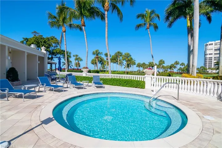 Jacuzzi alongside pool.