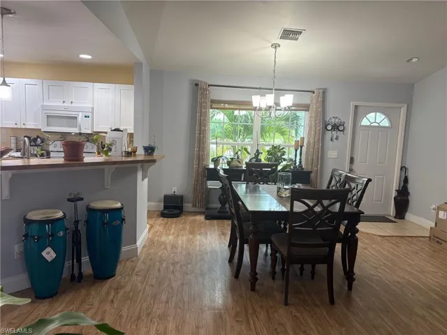 Dining area featuring recessed lighting, a chandelier, and light wood-type flooring