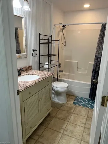 Bathroom with vanity and shower / bath combo with shower curtain
